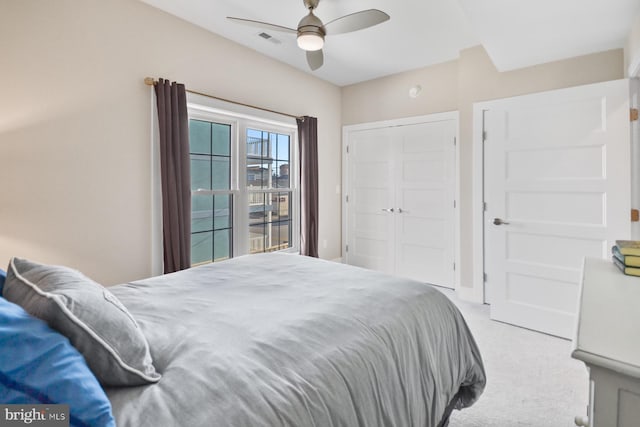 bedroom with light carpet and ceiling fan