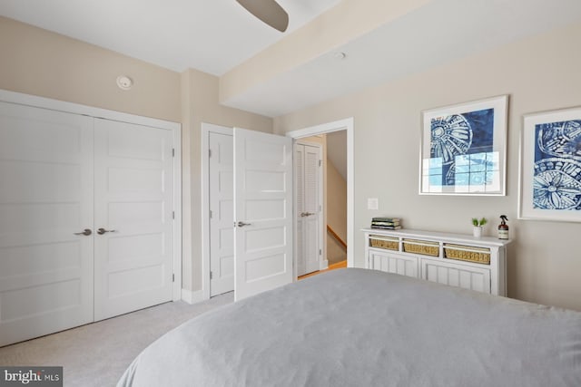 bedroom with ceiling fan, a closet, and light carpet