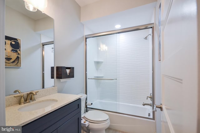 full bathroom with combined bath / shower with glass door, vanity, and toilet