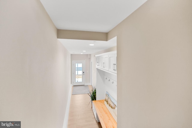 corridor with light hardwood / wood-style flooring