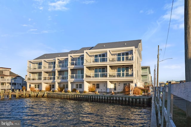 back of property featuring a water view