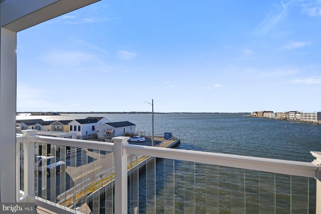 view of dock featuring a water view and a balcony