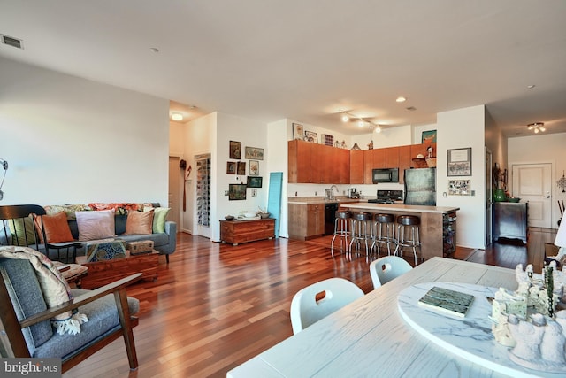 dining area with dark wood-type flooring and sink