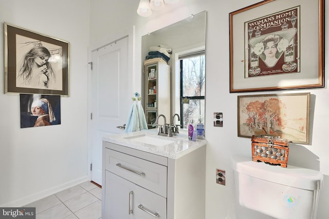 bathroom featuring tile patterned flooring, vanity, and toilet