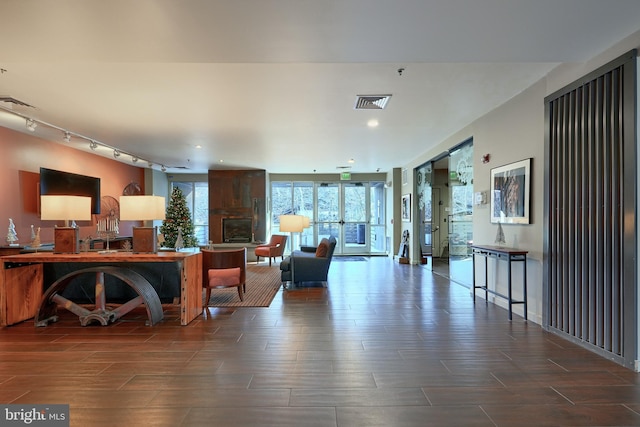 living room with wood-type flooring and track lighting