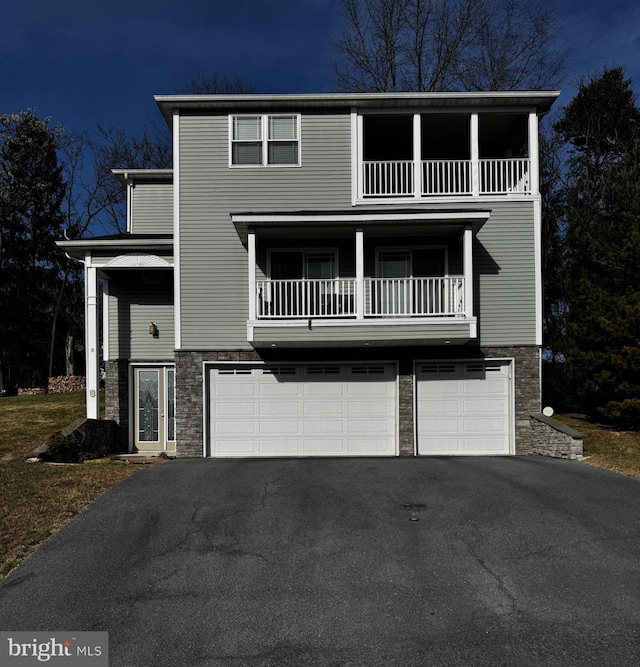 view of front of house with a garage and a balcony