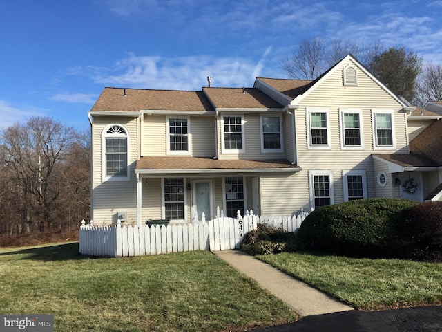 view of property featuring a front lawn