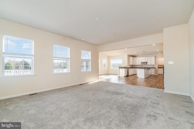 unfurnished living room with carpet