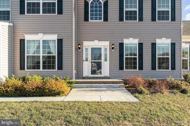 doorway to property featuring a yard