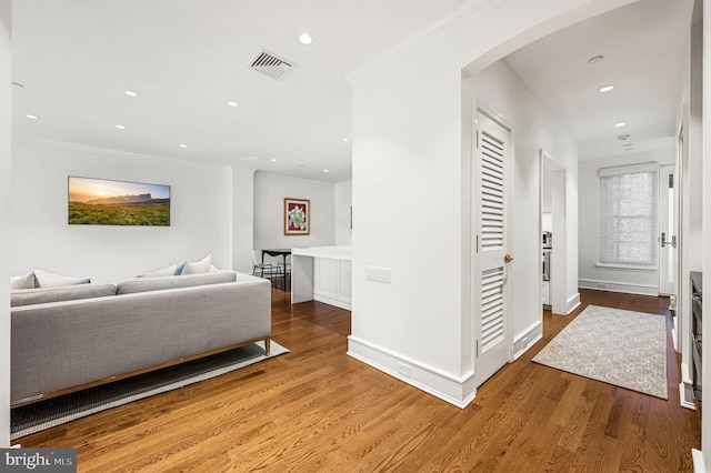 hall featuring crown molding and hardwood / wood-style floors