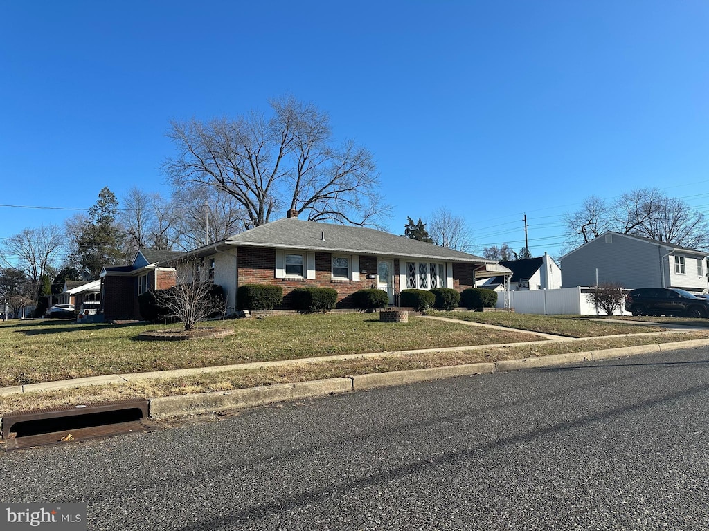 ranch-style home with a front lawn