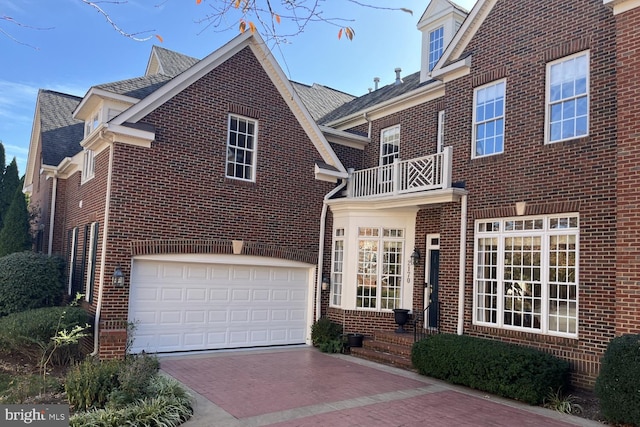 view of front of home featuring a balcony and a garage