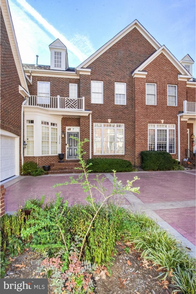 multi unit property with a garage and a balcony