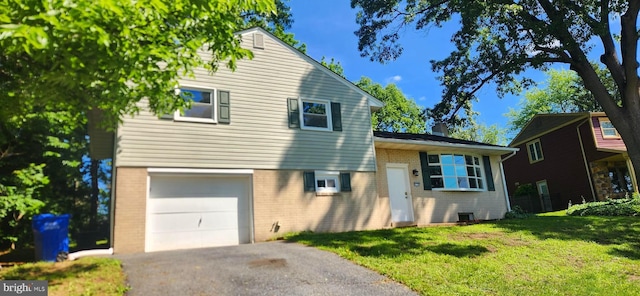 6130 Pine Knoll Dr, Harrisburg, PA 17111 - split level home with brick siding, a garage, a front lawn, a chimney, and asphalt driveway