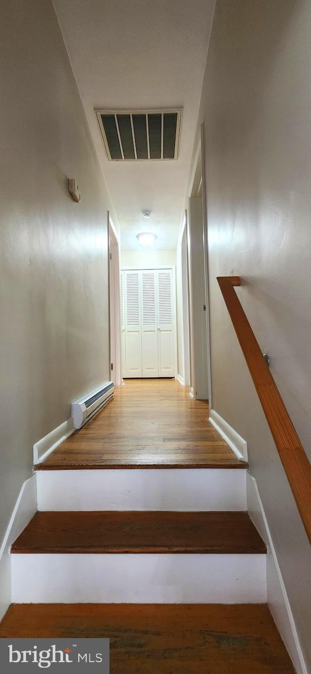 6130 Pine Knoll Dr, Harrisburg, PA 17111 - stairway with wood finished floors and a baseboard heating unit