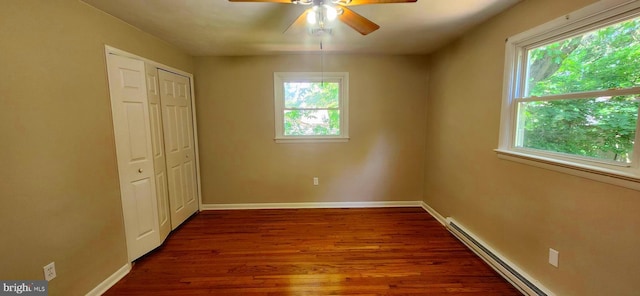 6130 Pine Knoll Dr, Harrisburg, PA 17111 - unfurnished bedroom with multiple windows, baseboard heating, dark wood finished floors, and baseboards
