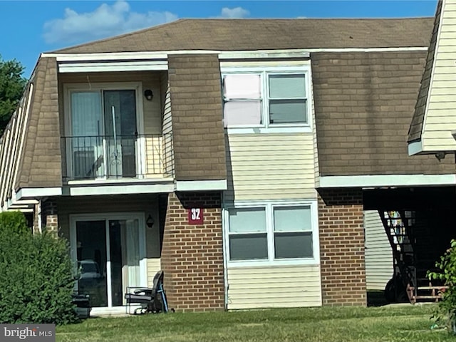 rear view of property with a lawn