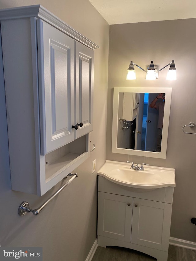 bathroom with hardwood / wood-style flooring and vanity