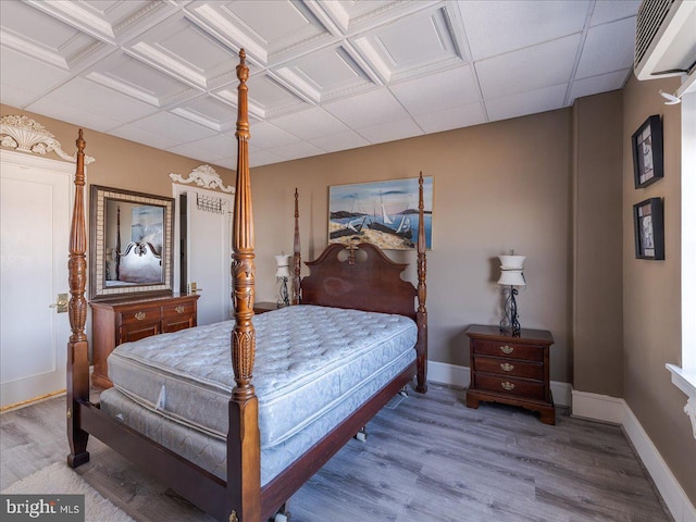 bedroom featuring an AC wall unit and hardwood / wood-style floors