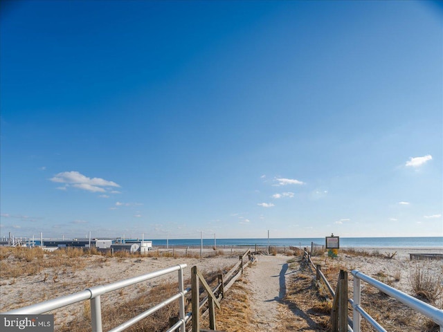 view of yard with a beach view and a water view