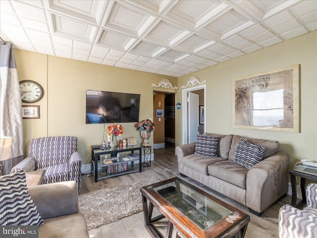 living room with light hardwood / wood-style floors and coffered ceiling