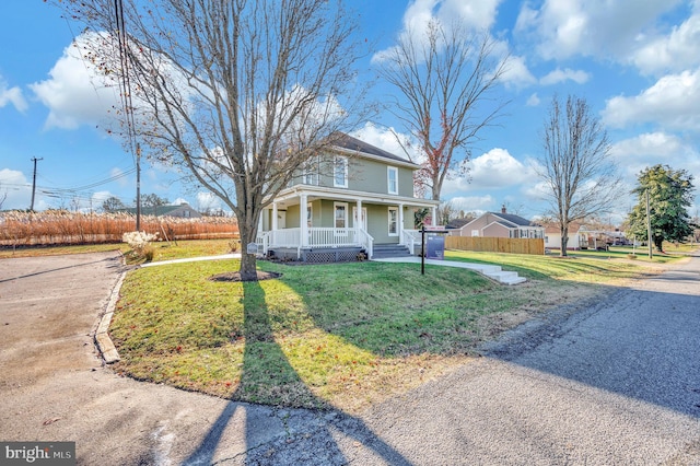 view of front facade featuring covered porch and a front lawn