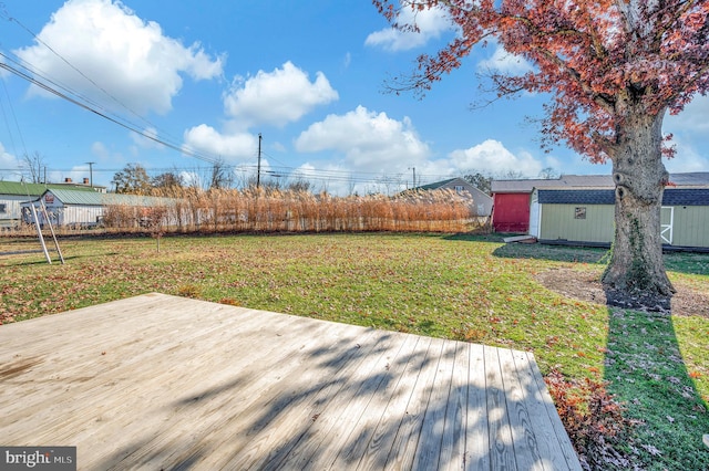 view of yard featuring a storage shed and a deck