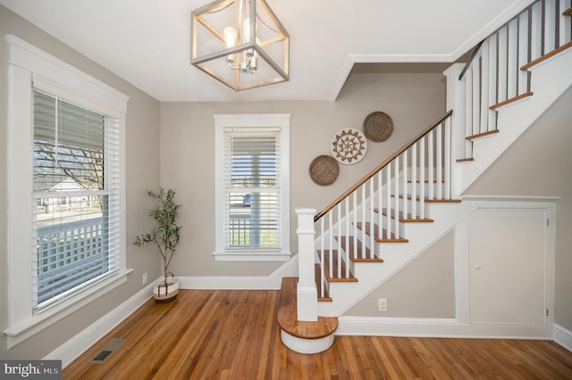 entryway featuring a chandelier and hardwood / wood-style flooring