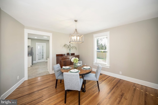 dining area featuring a chandelier and light wood-type flooring