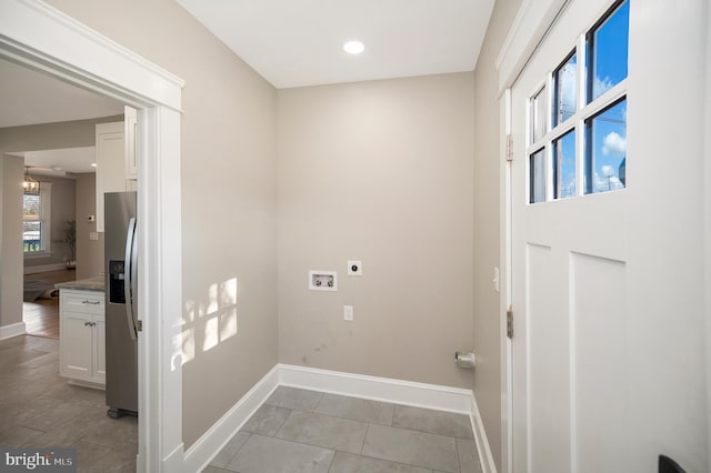 laundry room featuring washer hookup, electric dryer hookup, and light tile patterned floors