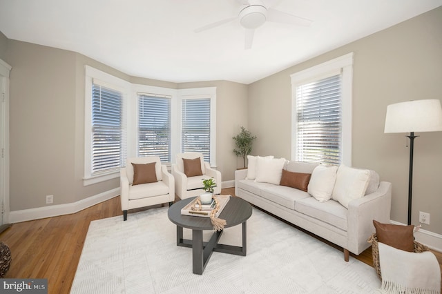 living room featuring ceiling fan and light hardwood / wood-style flooring