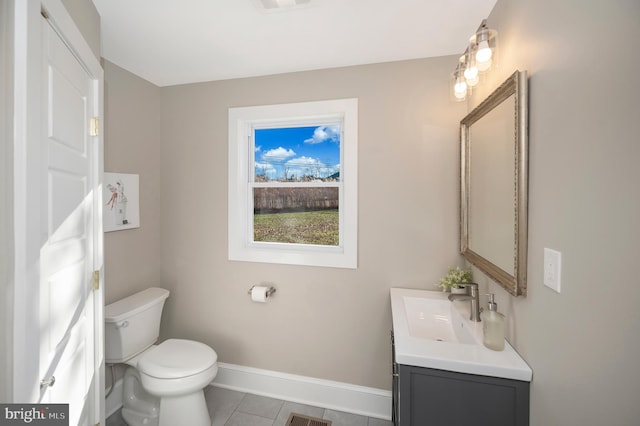 bathroom featuring tile patterned flooring, vanity, and toilet