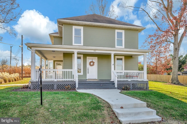 view of front of house with covered porch and a front lawn