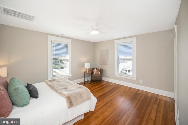 bedroom featuring multiple windows, ceiling fan, and hardwood / wood-style floors