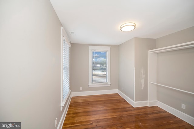 empty room with dark hardwood / wood-style floors