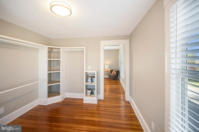 hallway with hardwood / wood-style floors