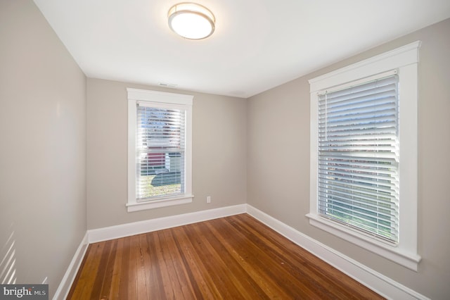 unfurnished room with wood-type flooring