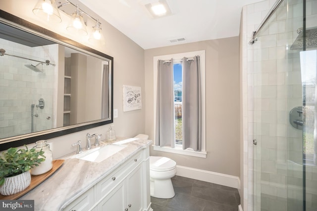 bathroom with tile patterned flooring, vanity, toilet, and a shower with shower door