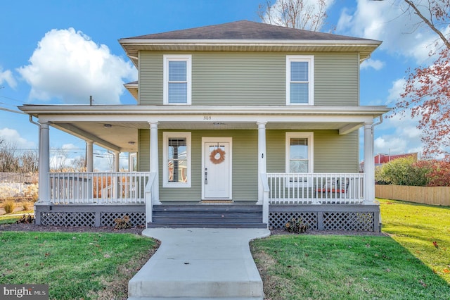 view of front of home featuring covered porch and a front yard