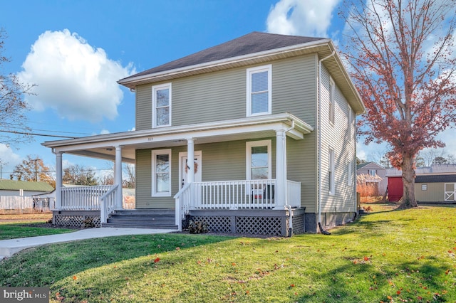 view of front of home with covered porch and a front lawn