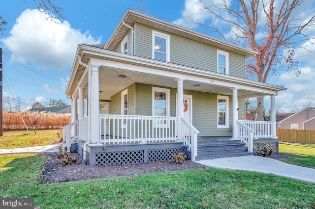 view of front of house featuring covered porch and a front yard