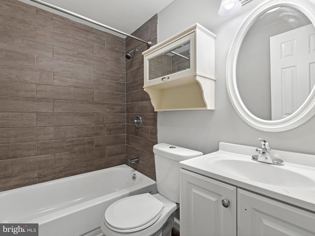 full bathroom with tiled shower / bath combo, toilet, and vanity