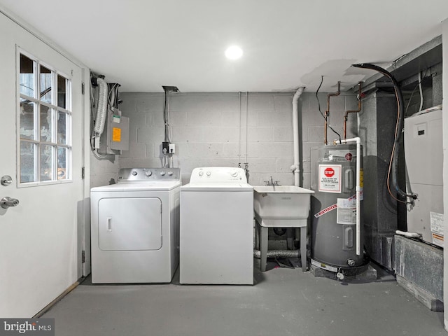 clothes washing area with electric panel, electric water heater, sink, and washer and dryer