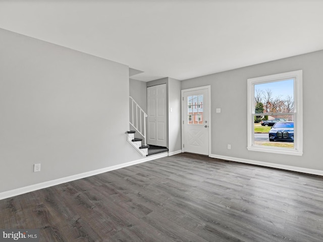 interior space with dark hardwood / wood-style flooring and a healthy amount of sunlight