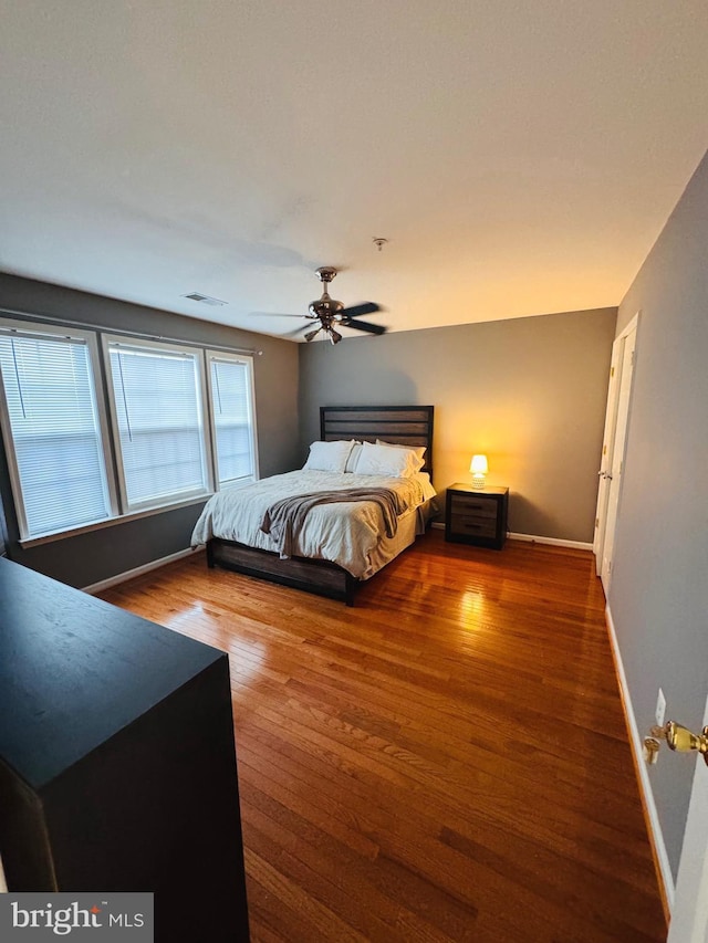 bedroom featuring wood-type flooring and ceiling fan