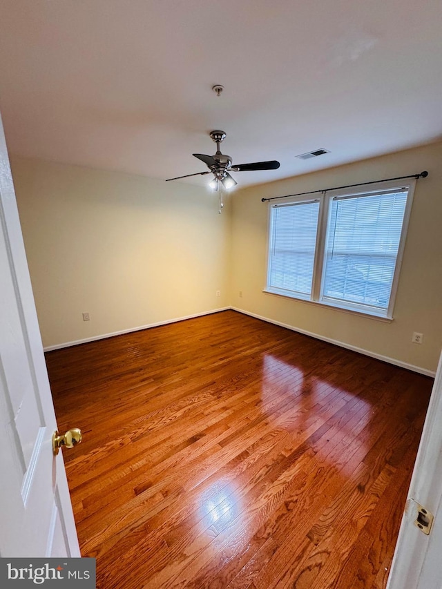 unfurnished room featuring hardwood / wood-style floors and ceiling fan