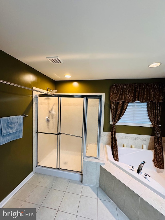 bathroom featuring tile patterned flooring and shower with separate bathtub