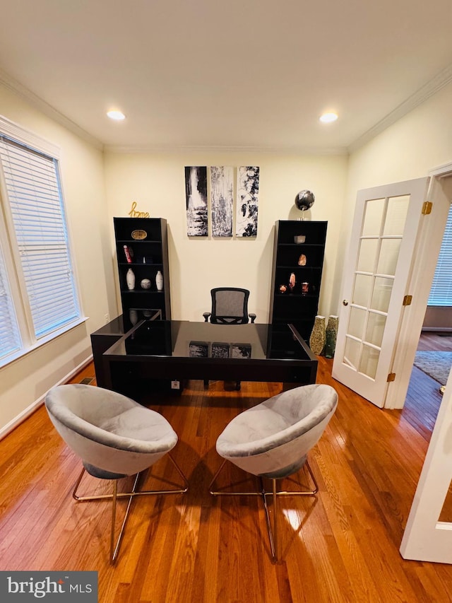 dining space featuring crown molding and wood-type flooring