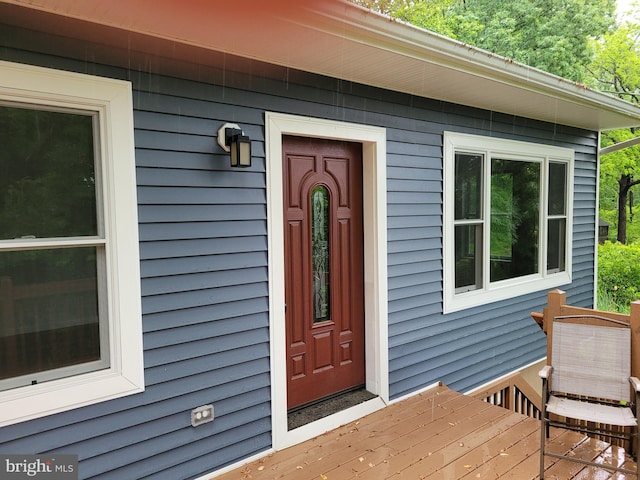 view of exterior entry with a deck