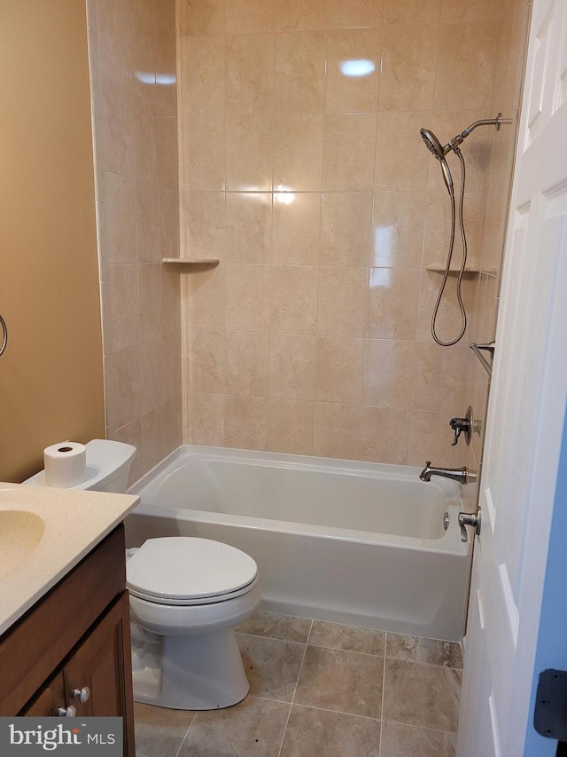 full bathroom featuring tile patterned floors, vanity, toilet, and tiled shower / bath combo